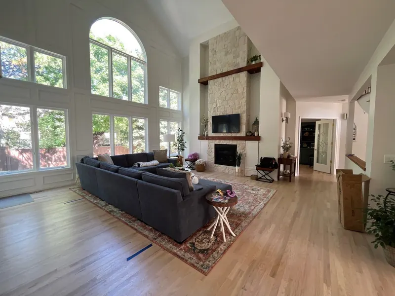 Repainted great room in soft white with stone fireplace