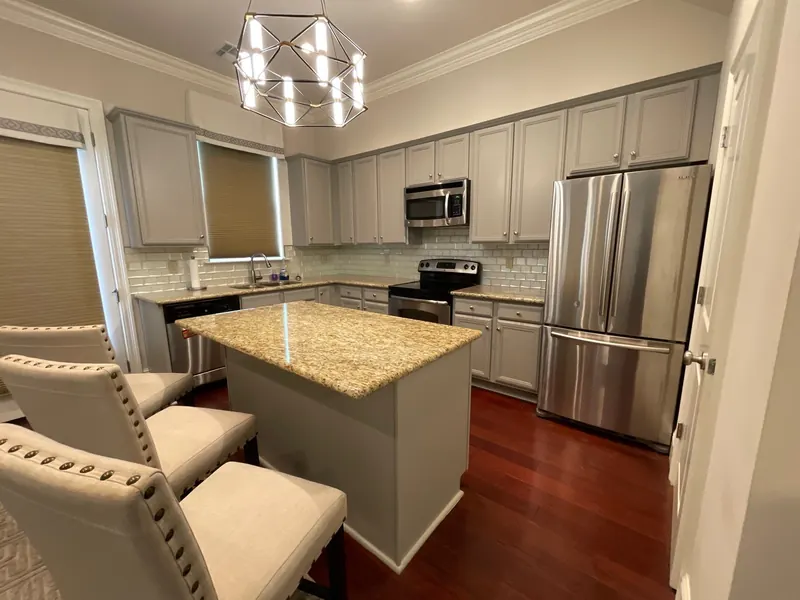Repainted gray kitchen cabinets with granite island